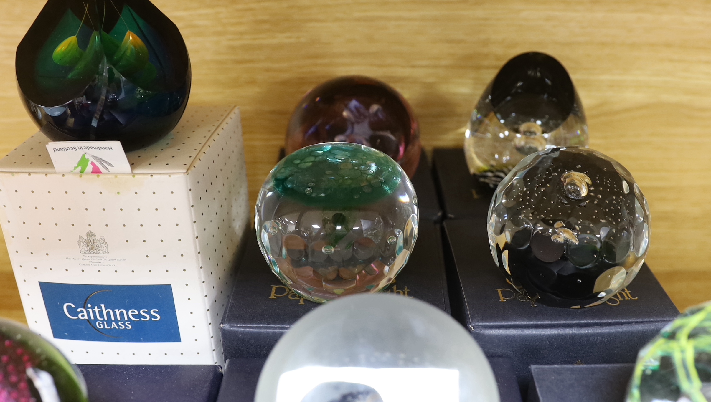 Nine Caithness paperweights including Arctic Night, limited edition 780/1500 and Sea nymphs, 114/350, each with boxes, the largest 9cm high